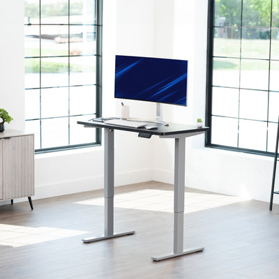 Sturdy ergonomic sit or stand active desk workstation with adjustable height using smart control panel.