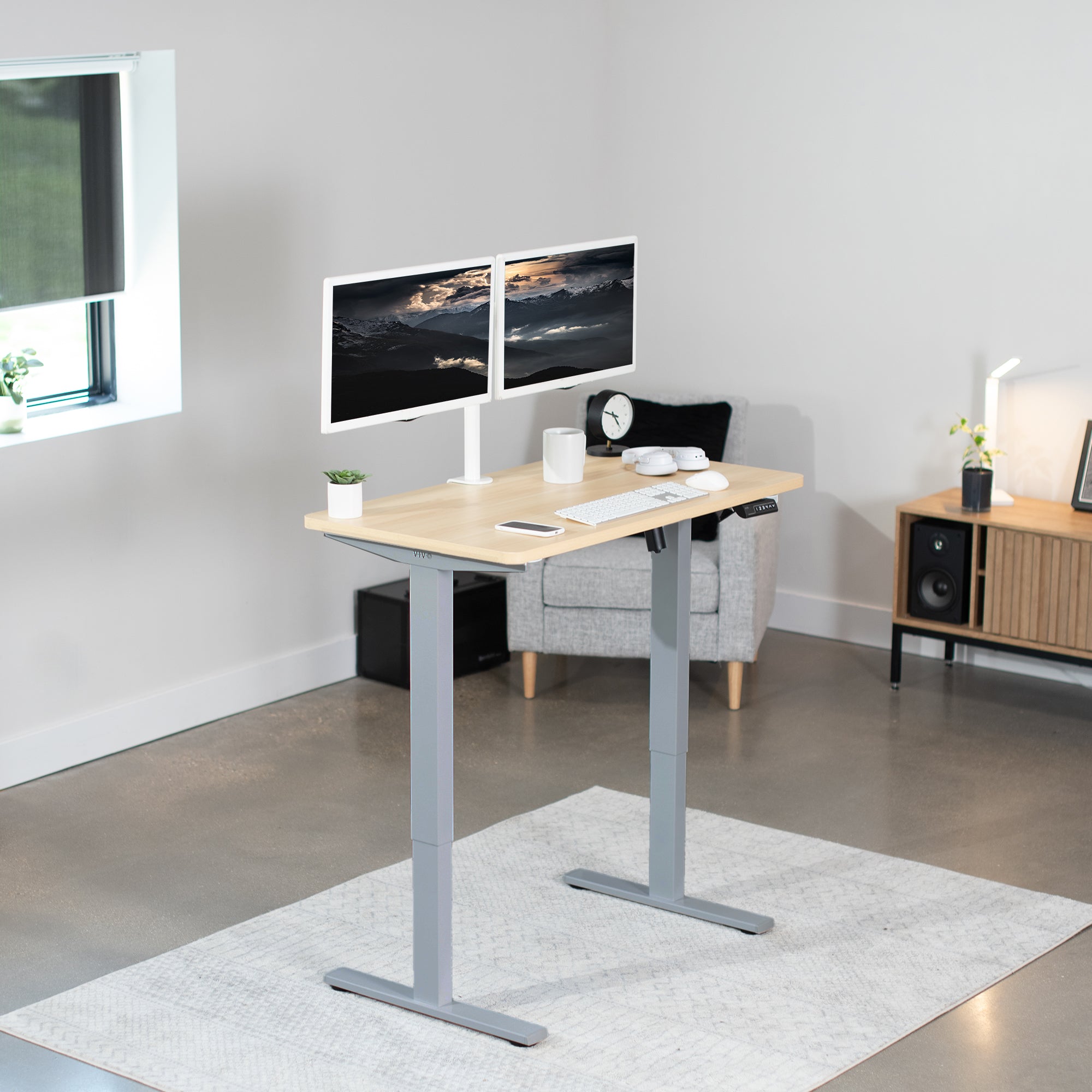 Sturdy ergonomic sit or stand active desk workstation with adjustable height using smart control panel.