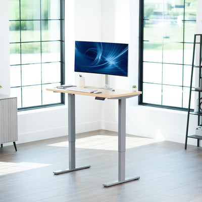 Sturdy ergonomic sit or stand active desk workstation with adjustable height using smart control panel.