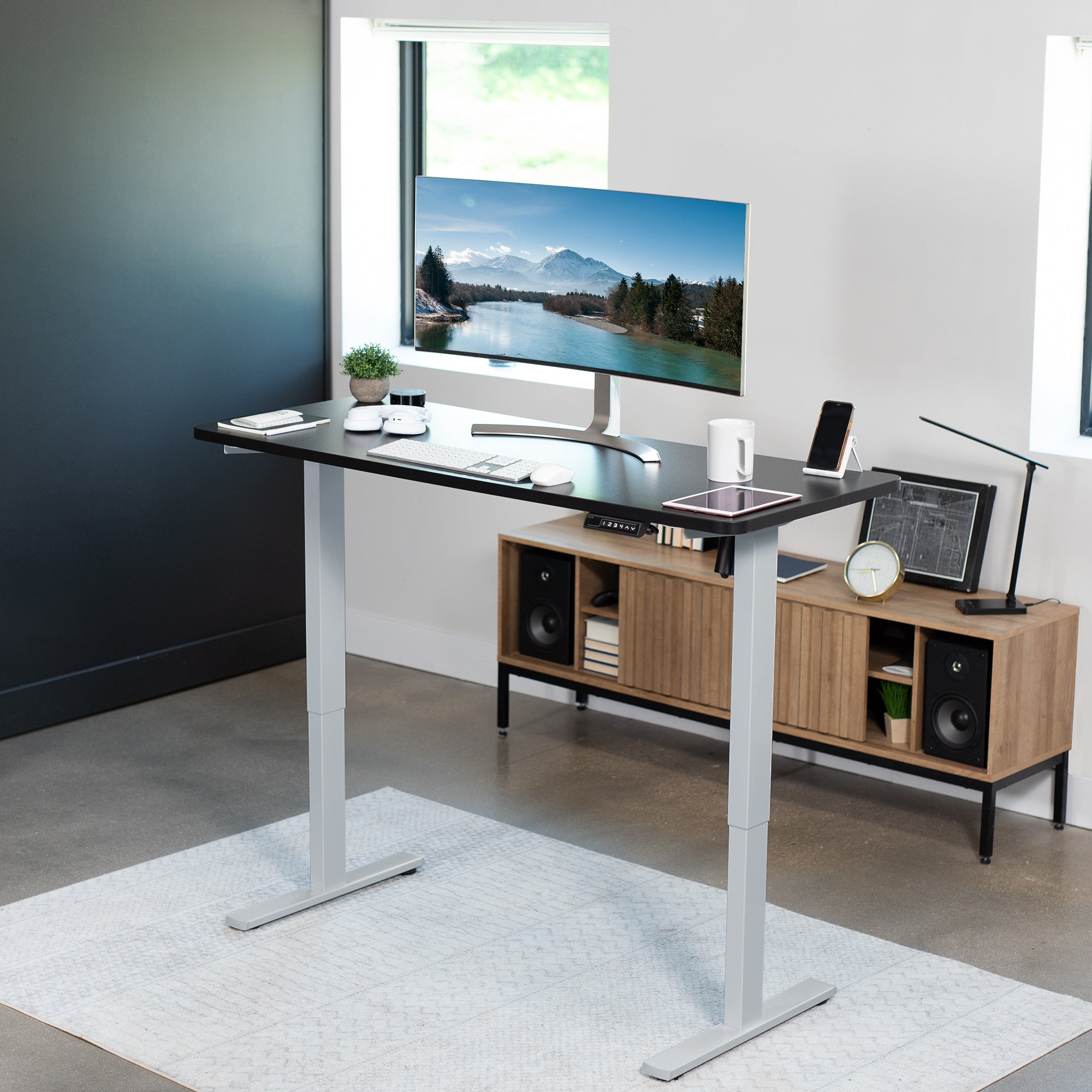 Sturdy ergonomic sit or stand active desk workstation with adjustable height using smart control panel.