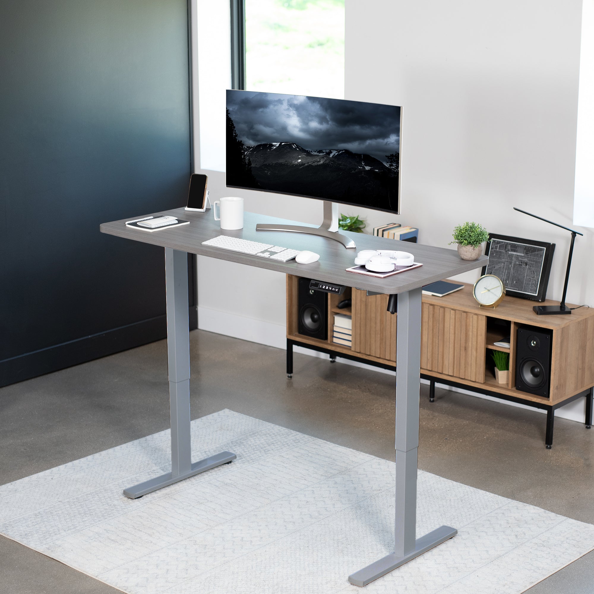 Sturdy ergonomic sit or stand active desk workstation with adjustable height using smart control panel.