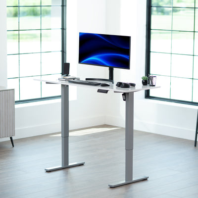 Sturdy ergonomic sit or stand active desk workstation with adjustable height using smart control panel.