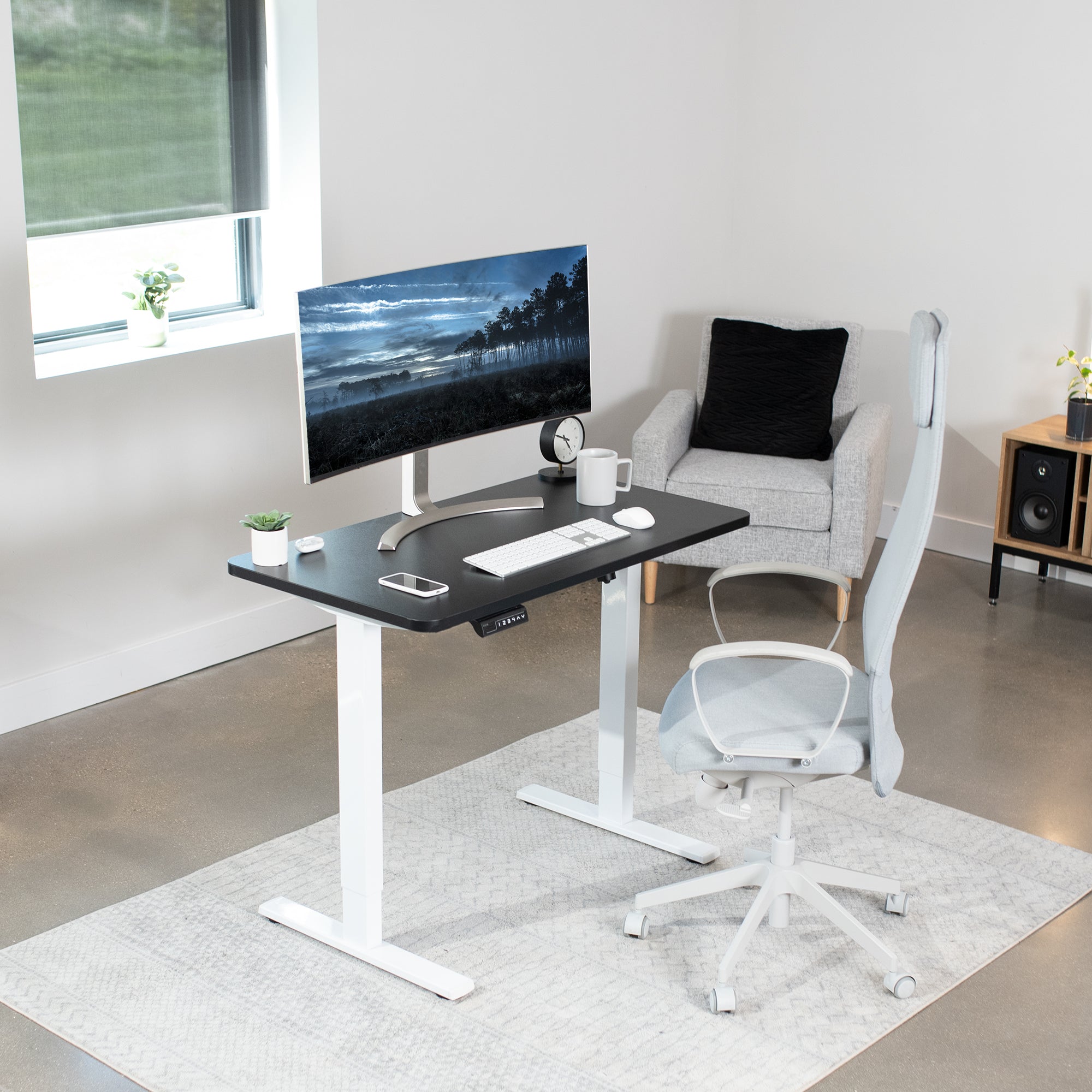 Sturdy ergonomic sit or stand active desk workstation with adjustable height using smart control panel.