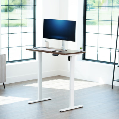 Sturdy ergonomic sit or stand active desk workstation with adjustable height using smart control panel.