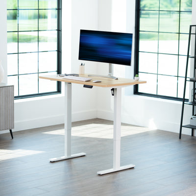 Sturdy ergonomic sit or stand active desk workstation with adjustable height using smart control panel.