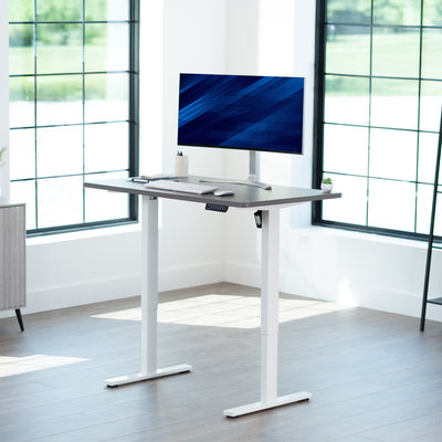 Sturdy ergonomic sit or stand active desk workstation with adjustable height using smart control panel.