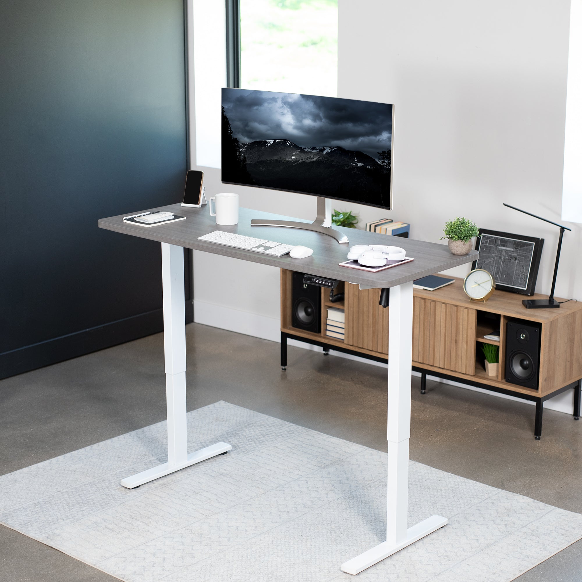 Sturdy ergonomic sit or stand active desk workstation with adjustable height using smart control panel.