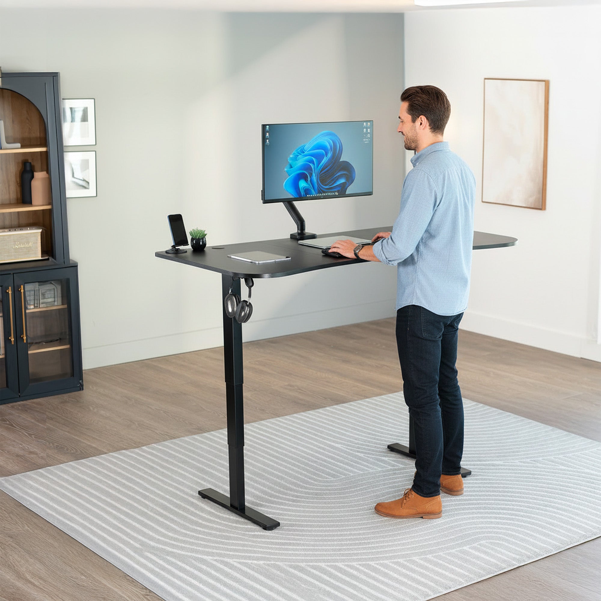 63” x 32” Electric Height Adjustable Stand Up Desk. Features a built-in power strip.
