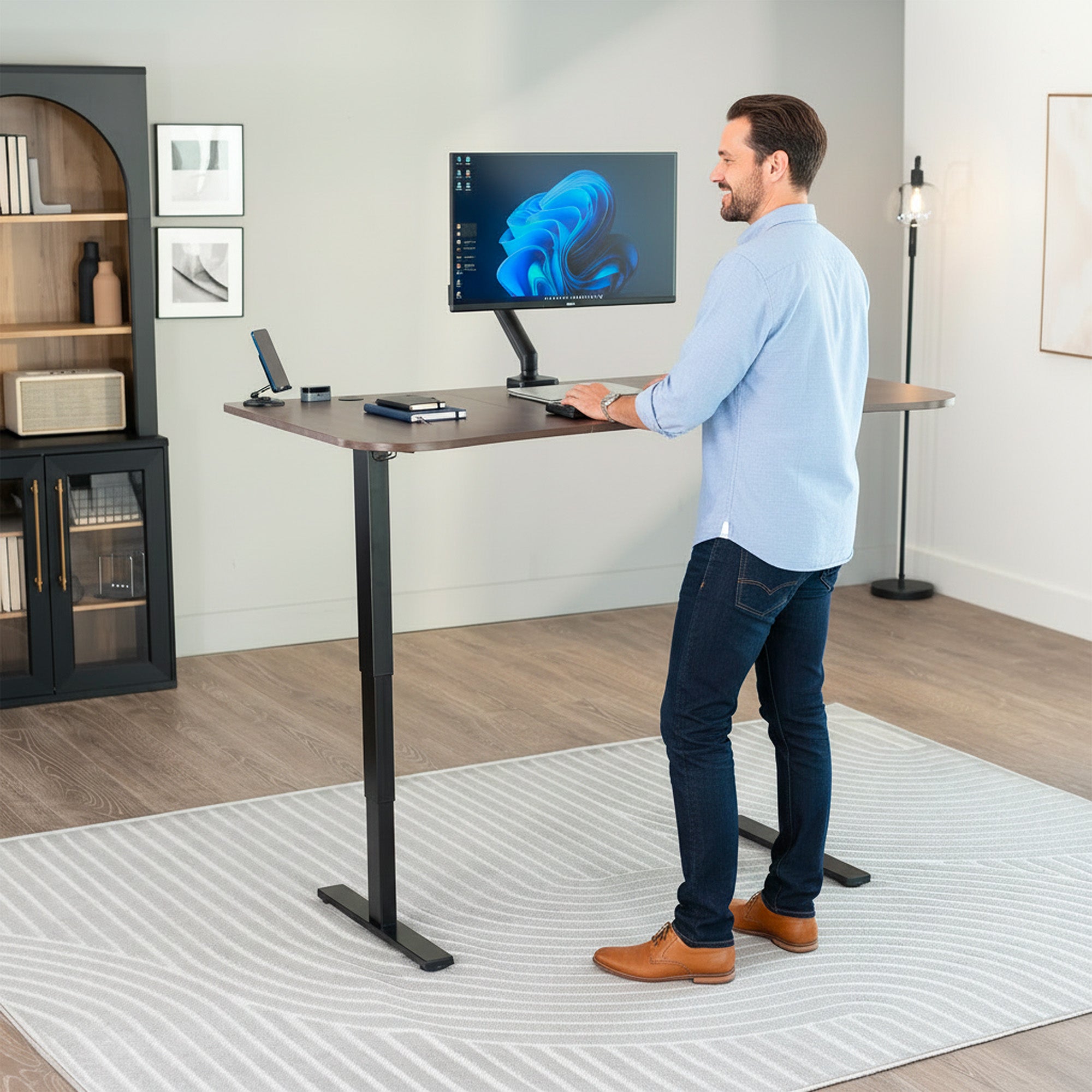 63” x 32” Electric Height Adjustable Stand Up Desk. Features a built-in power strip.