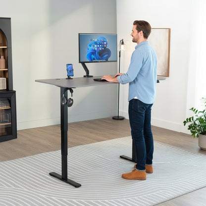 63” x 32” Electric Height Adjustable Stand Up Desk. Features a built-in power strip.