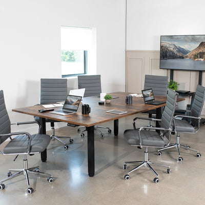 Dual Motor Electric 4-Leg Desk with Square Corner Top provides a spacious workstation for a conference room or project table and creates smooth height adjustment at the push of a button.