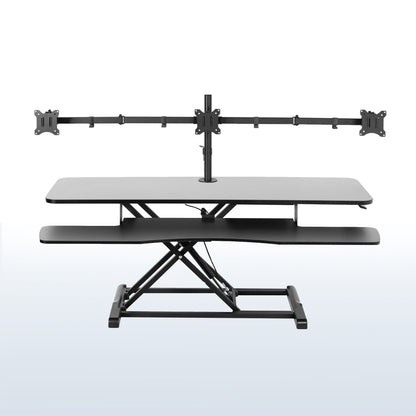 Spacious height adjustable desk riser with articulating triple monitor mount.