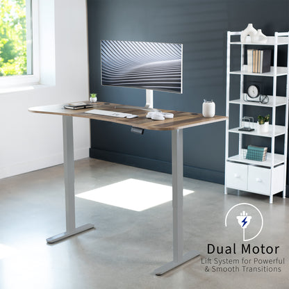 Heavy-duty electric sit to stand height adjustable ergonomic desk workstation with programmable memory controller for convenient productive workspace.