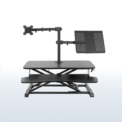 Sit to stand desk riser with built-in monitor mount and laptop mount.