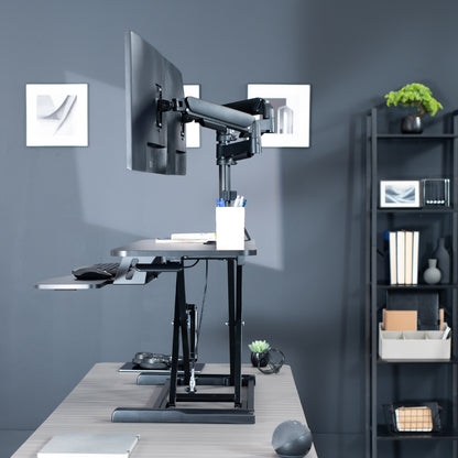 42 inch height adjustable desk riser with articulating mechanical dual monitor mount.