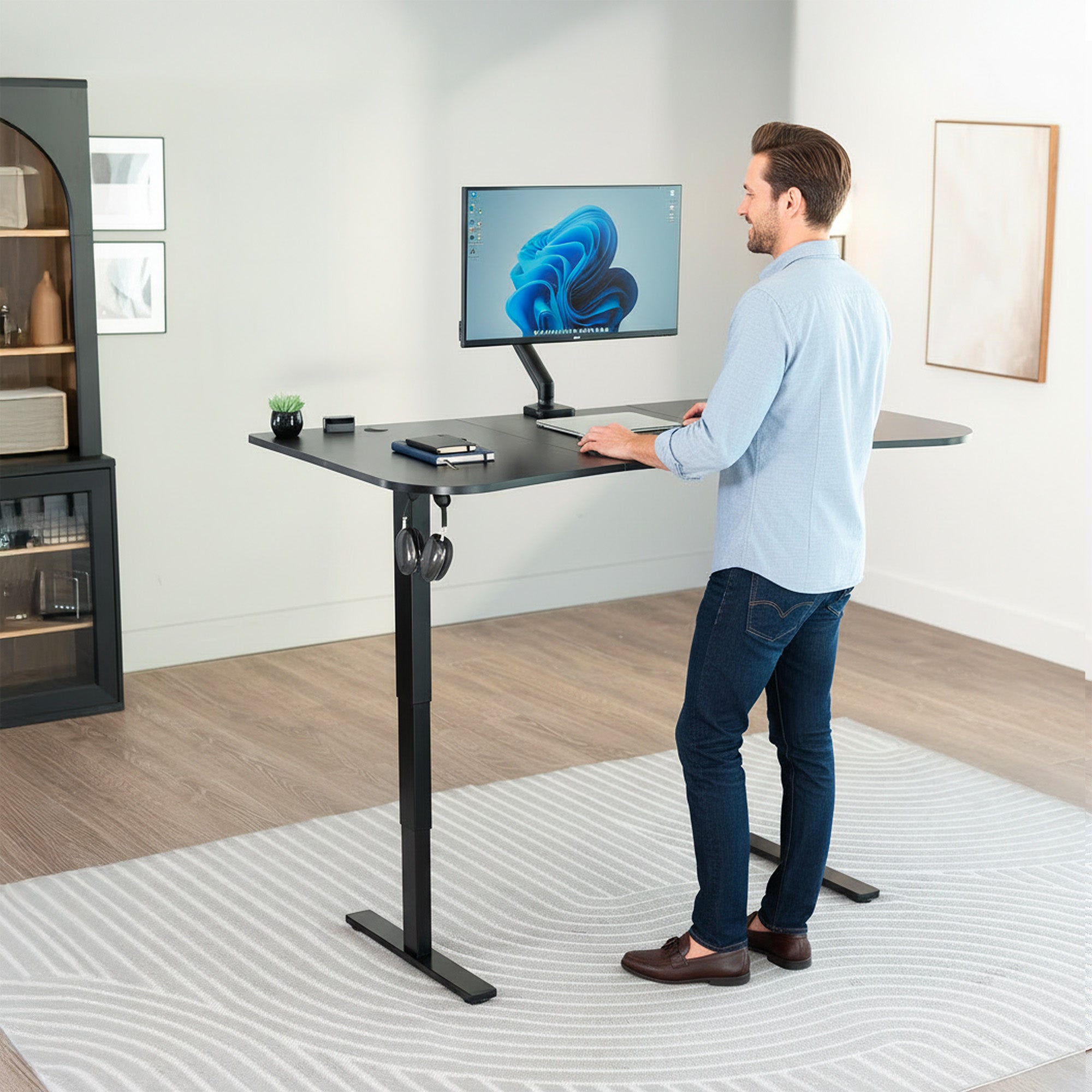63” x 32” Electric Height Adjustable Stand Up Desk. Features a built-in power strip.
