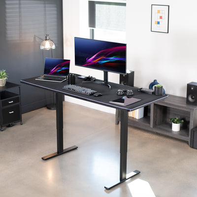 Durable sit to stand desk tabletop workstation with wide surface space and includes full-size LED USB powered RGB pad.