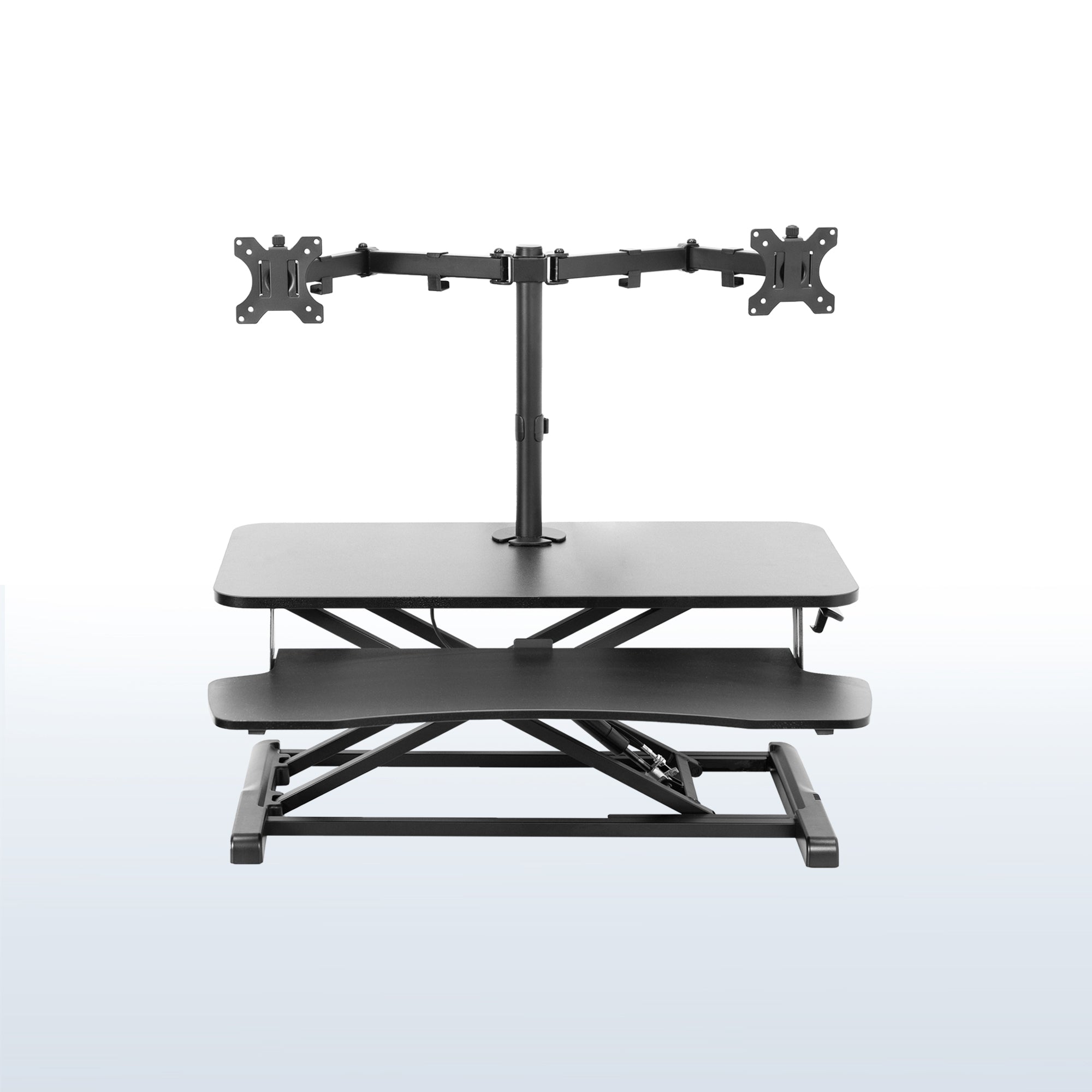 Sturdy height adjustable desk converter with articulating dual monitor mount.