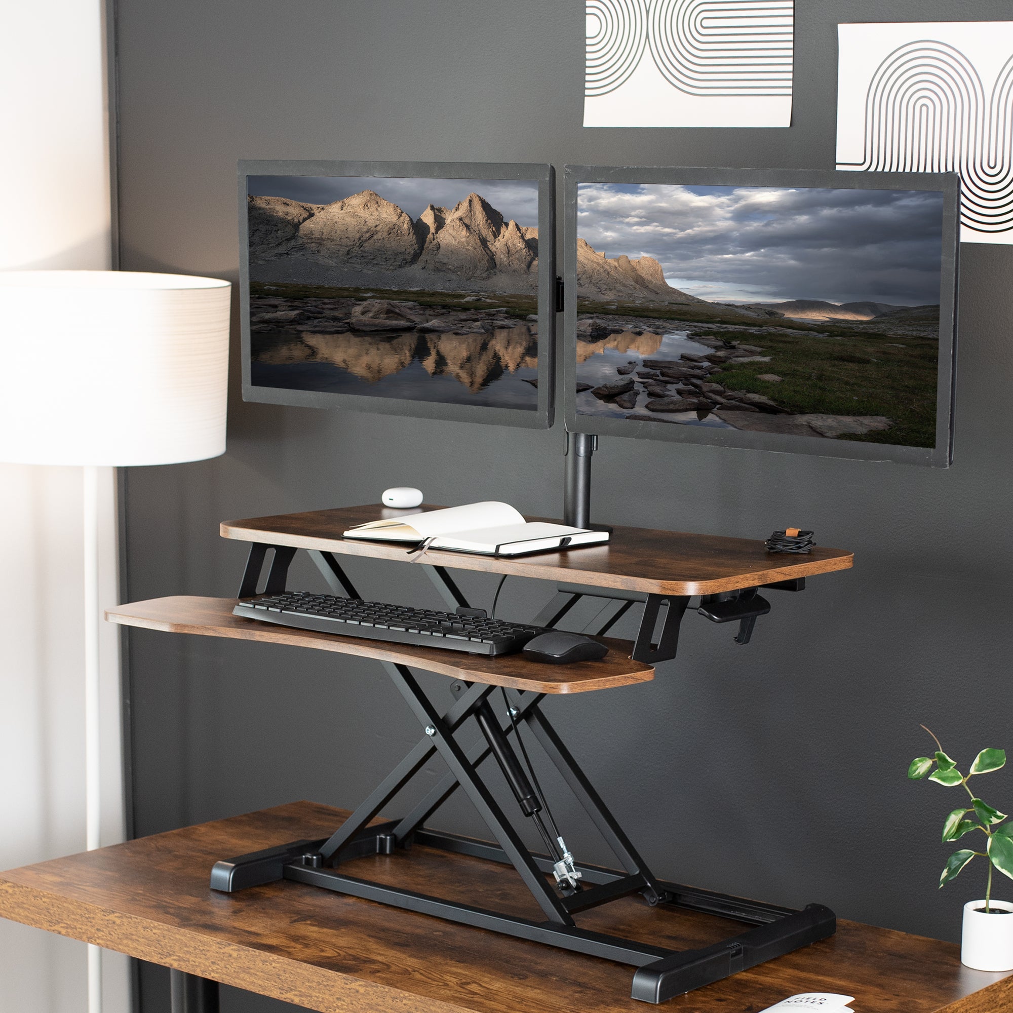 Sturdy height adjustable desk converter with articulating dual monitor mount.