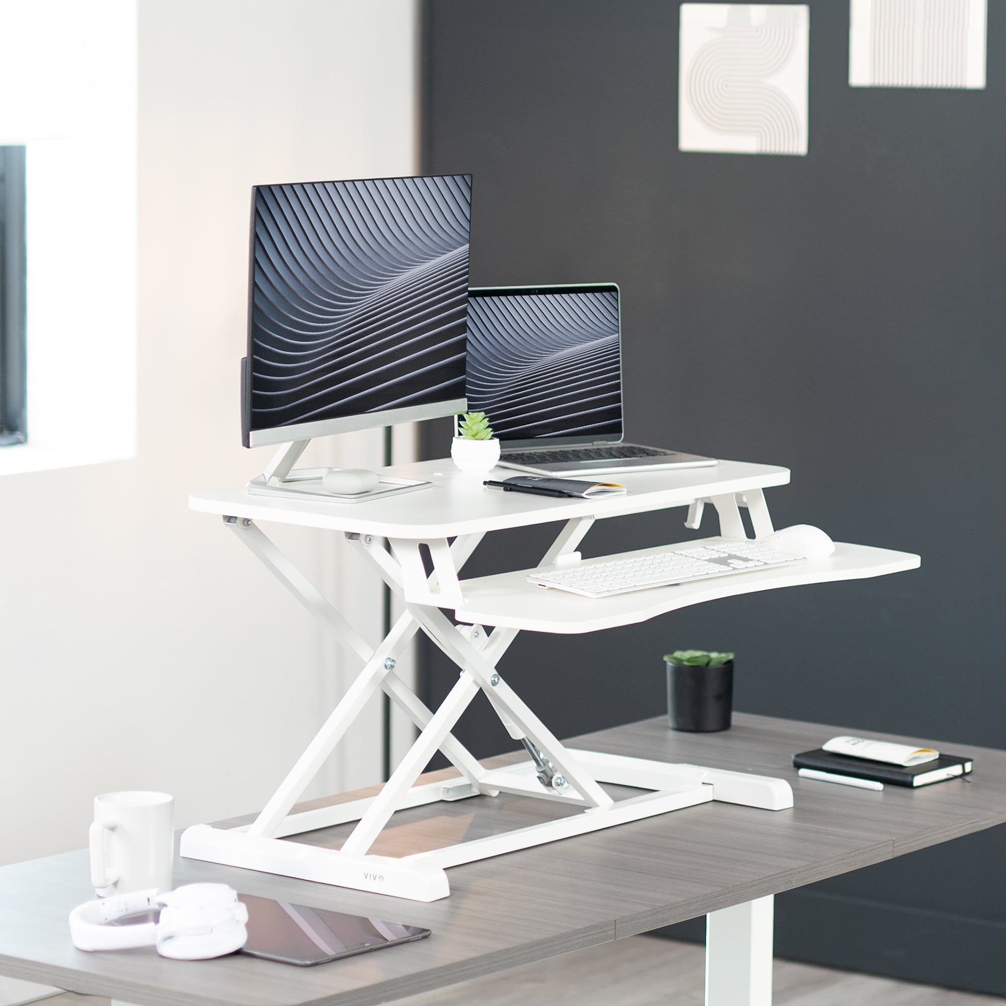 Sturdy height adjustable 2-tiered desk riser for ergonomic office workstation.