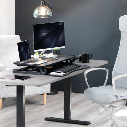 Sturdy height adjustable 2-tiered desk riser for ergonomic office workstation.