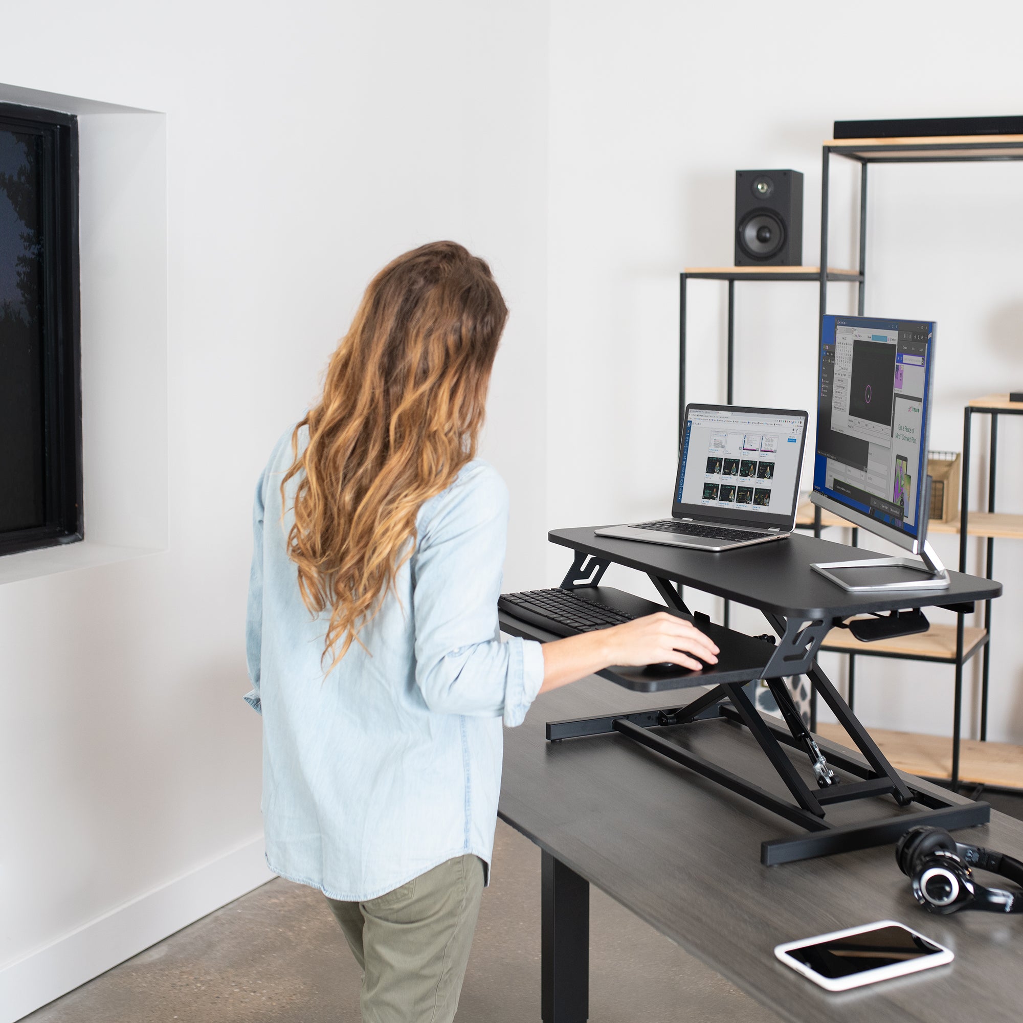 Heavy-duty height adjustable desk converter monitor riser with 2 tiers.