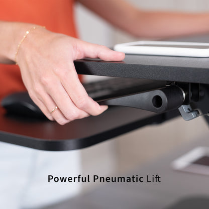 Sit stand desk converter sits on top of current desk and raises and lowers for a comfortable viewing and typing experience.