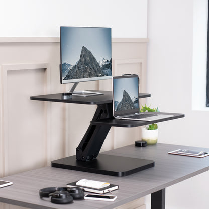 Sit stand desk converter sits on top of current desk and raises and lowers for a comfortable viewing and typing experience.