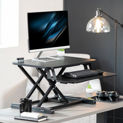 Sturdy height adjustable 2-tiered desk riser for ergonomic office workstation.