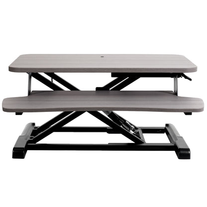 Sturdy height adjustable 2-tiered desk riser for ergonomic office workstation.