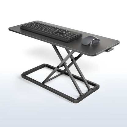 Black adjustable standing desk with keyboard and mouse on a blue and white gradient background