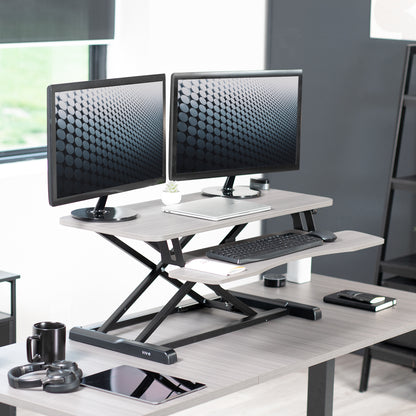 Sturdy height adjustable 2-tiered desk riser for ergonomic office workstation.