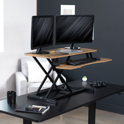 Sturdy height adjustable 2-tiered rustic desk riser for ergonomic office workstation.