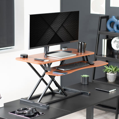 Heavy-duty height adjustable desk converter monitor riser with 2 tiers.