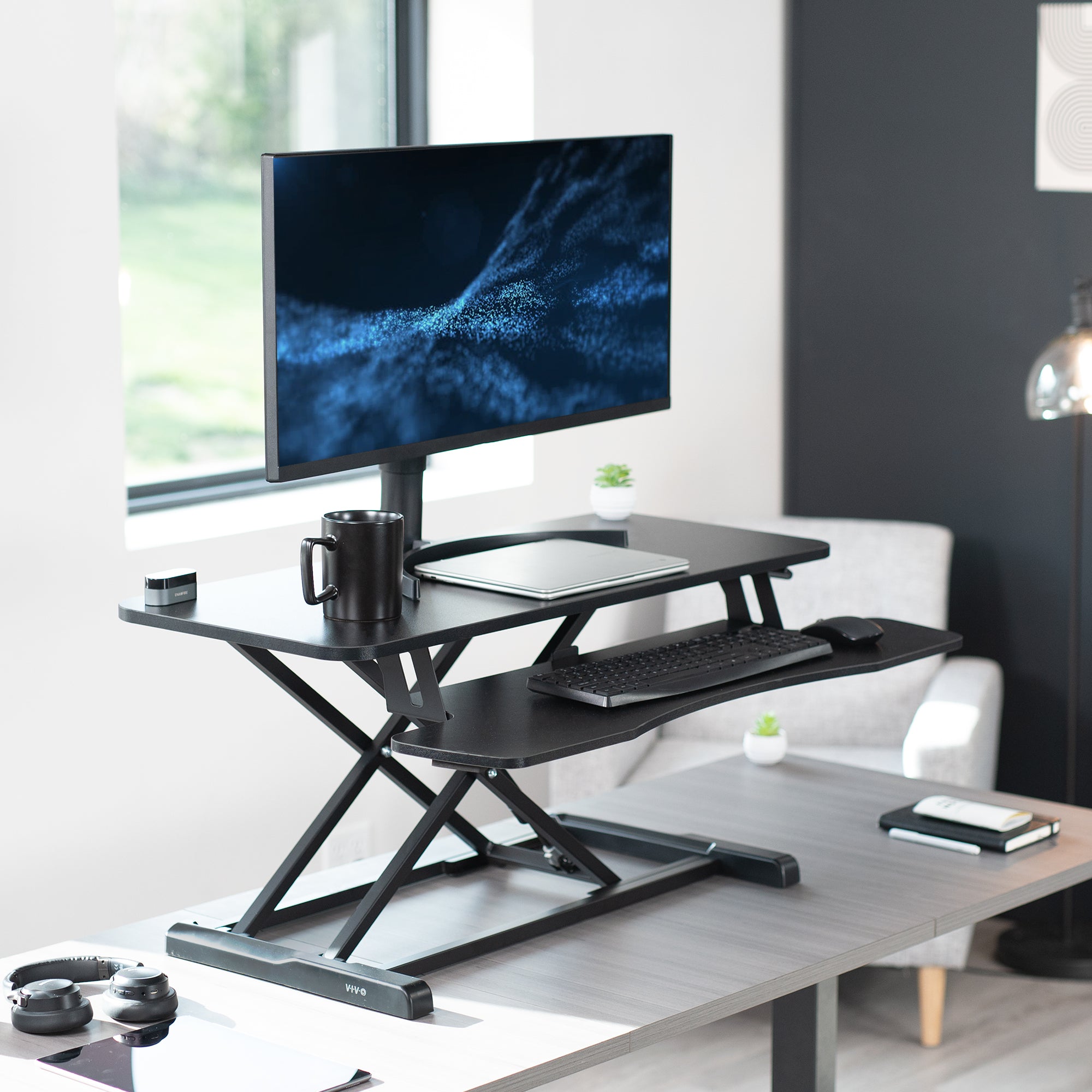 Heavy-duty height adjustable desk converter monitor riser with 2 tiers.