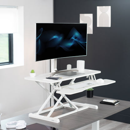 Heavy-duty height adjustable desk converter monitor riser with 2 tiers.