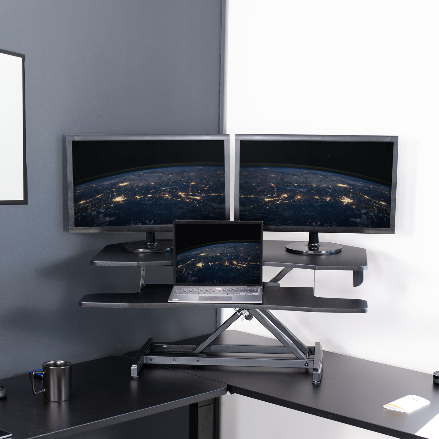 Heavy-duty height adjustable desk converter monitor riser for corner desk workstation.