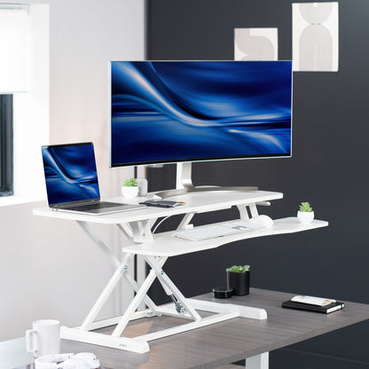 Sturdy height adjustable 2-tiered desk riser for ergonomic office workstation.