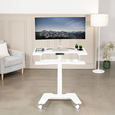 Electric mobile compact desk provides a height adjustable workstation for home or the office, featuring a 2 tier design for your screen and keyboard tray.