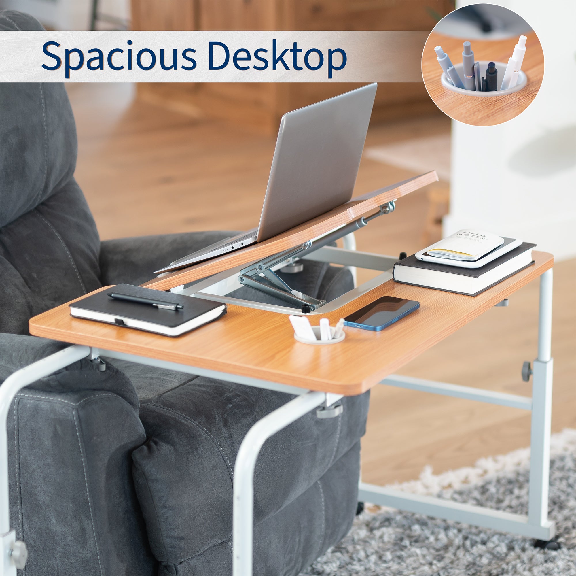 Portable desk over a recliner with laptop, books, and phone on the wooden top.