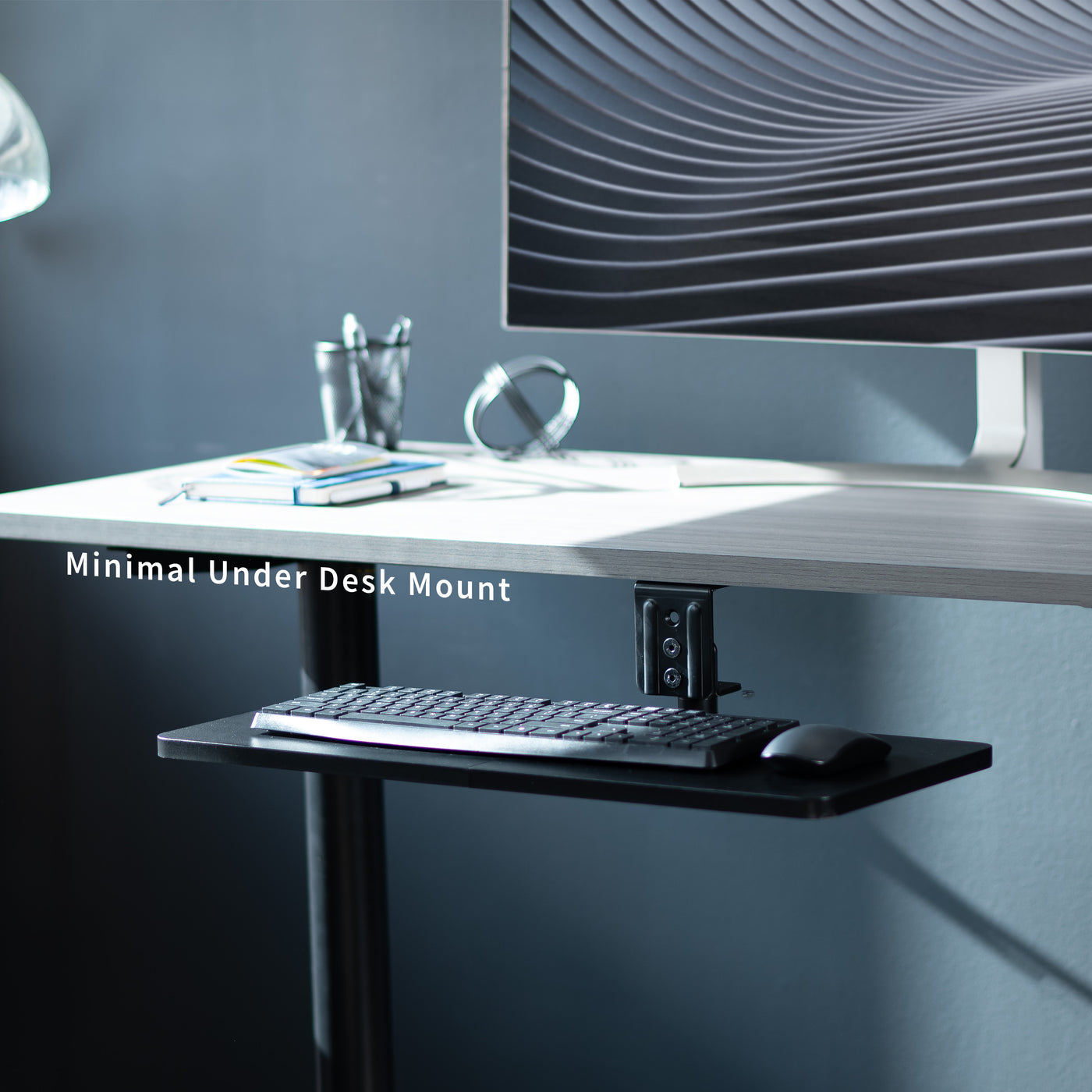 Low-profile under desk keyboard tray with 360-degree rotation.