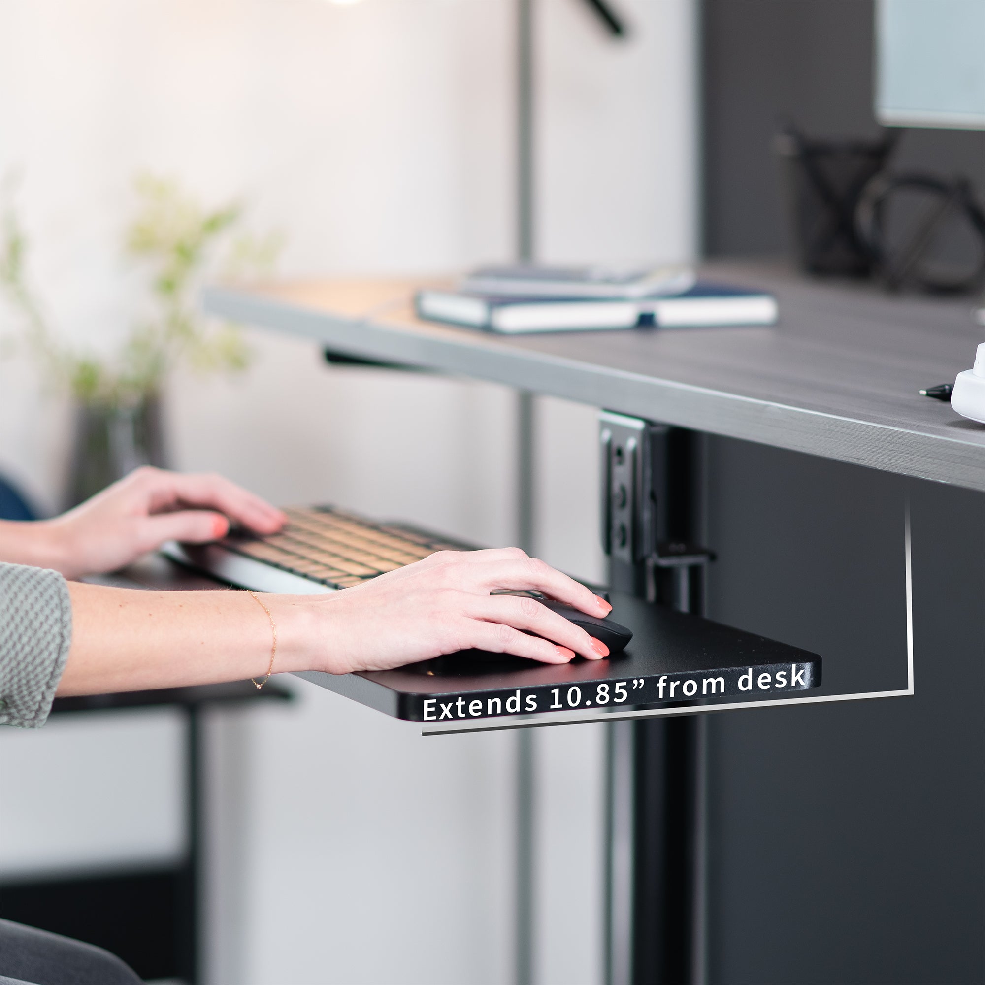 Low-profile under desk keyboard tray with 360-degree rotation.