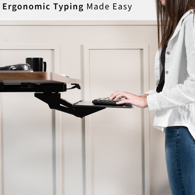 Person using an ergonomic keyboard stand with text 'Ergonomic Typing Made Easy' above.