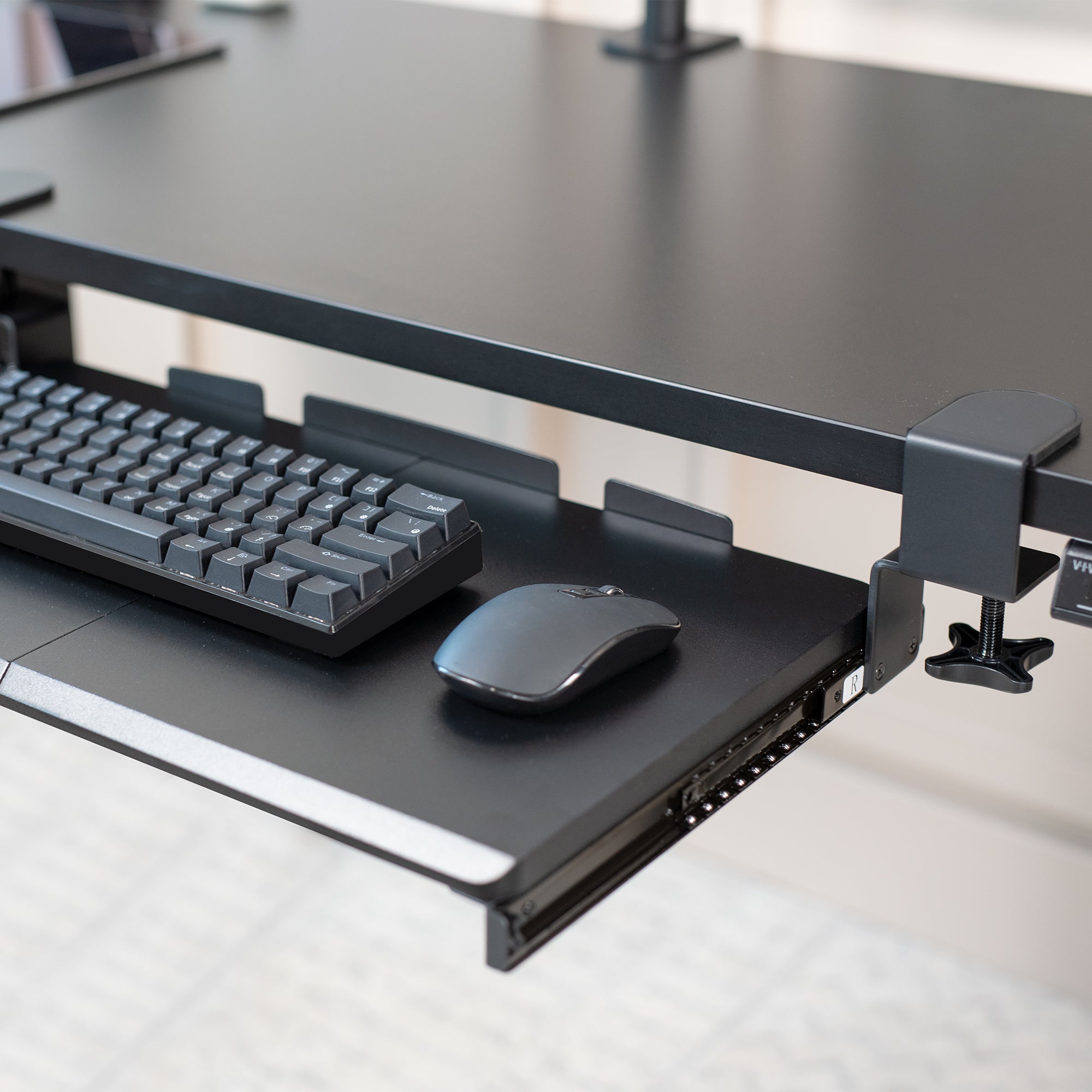 Compact clamp-on pullout keyboard tray.