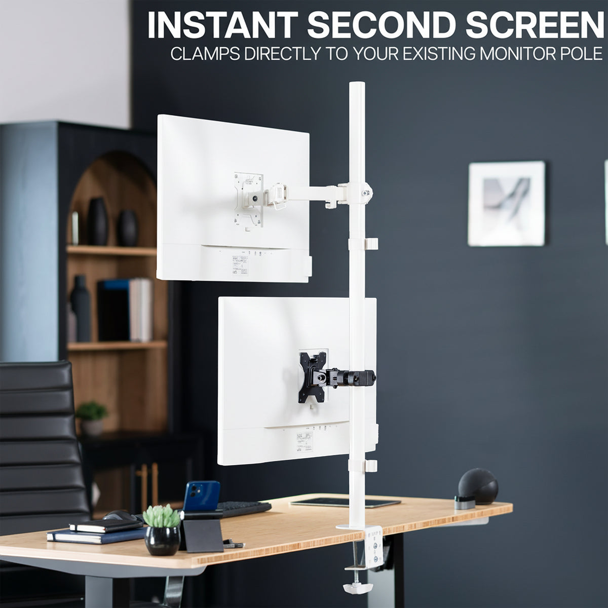 Desk setup with a monitor stand and additional screen attachment via the VESA pole mount bracket in an office setting.