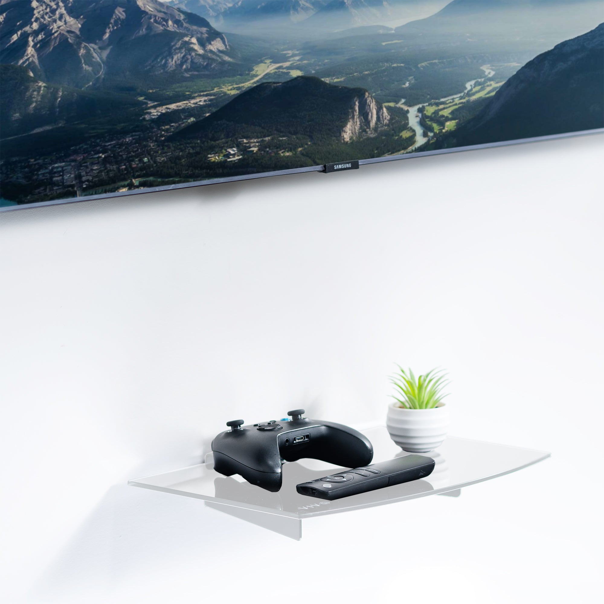 Modern look white tempered glass floating shelf with sturdy steel frame installed below a TV.