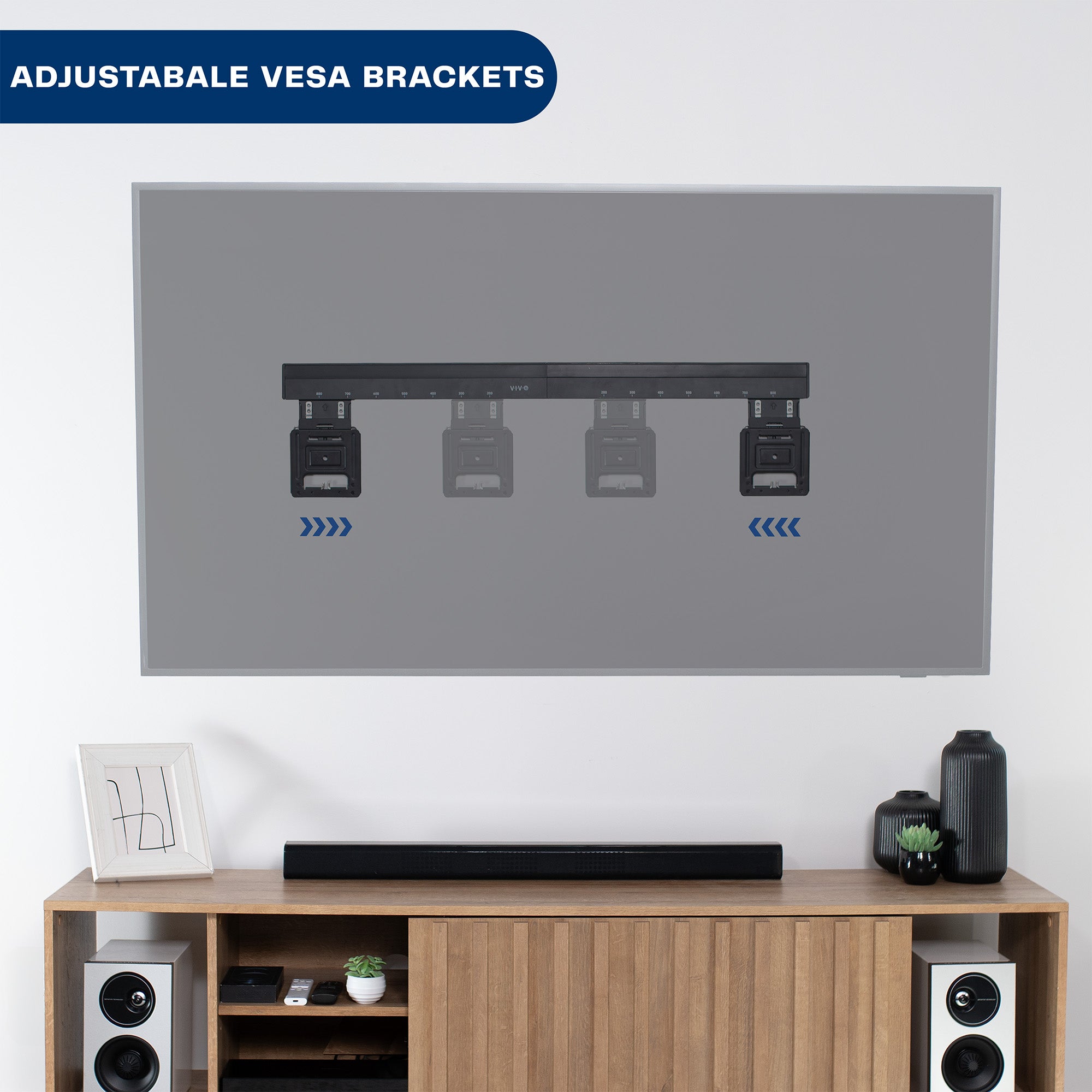 TV mounted on a wall with adjustable VESA brackets above a wooden entertainment console.