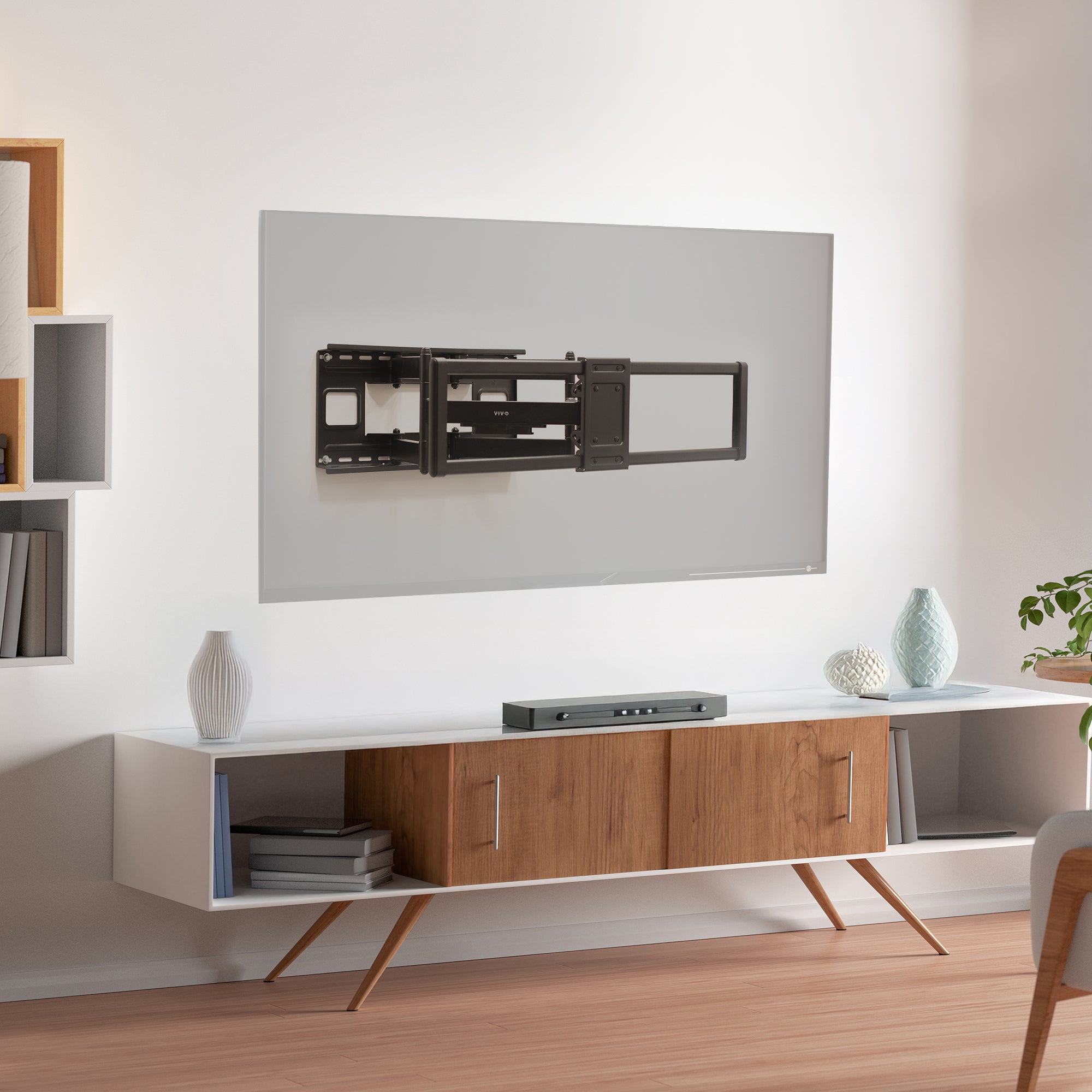 Modern living room with a flat-screen TV mounted on the wall above a wooden entertainment console.