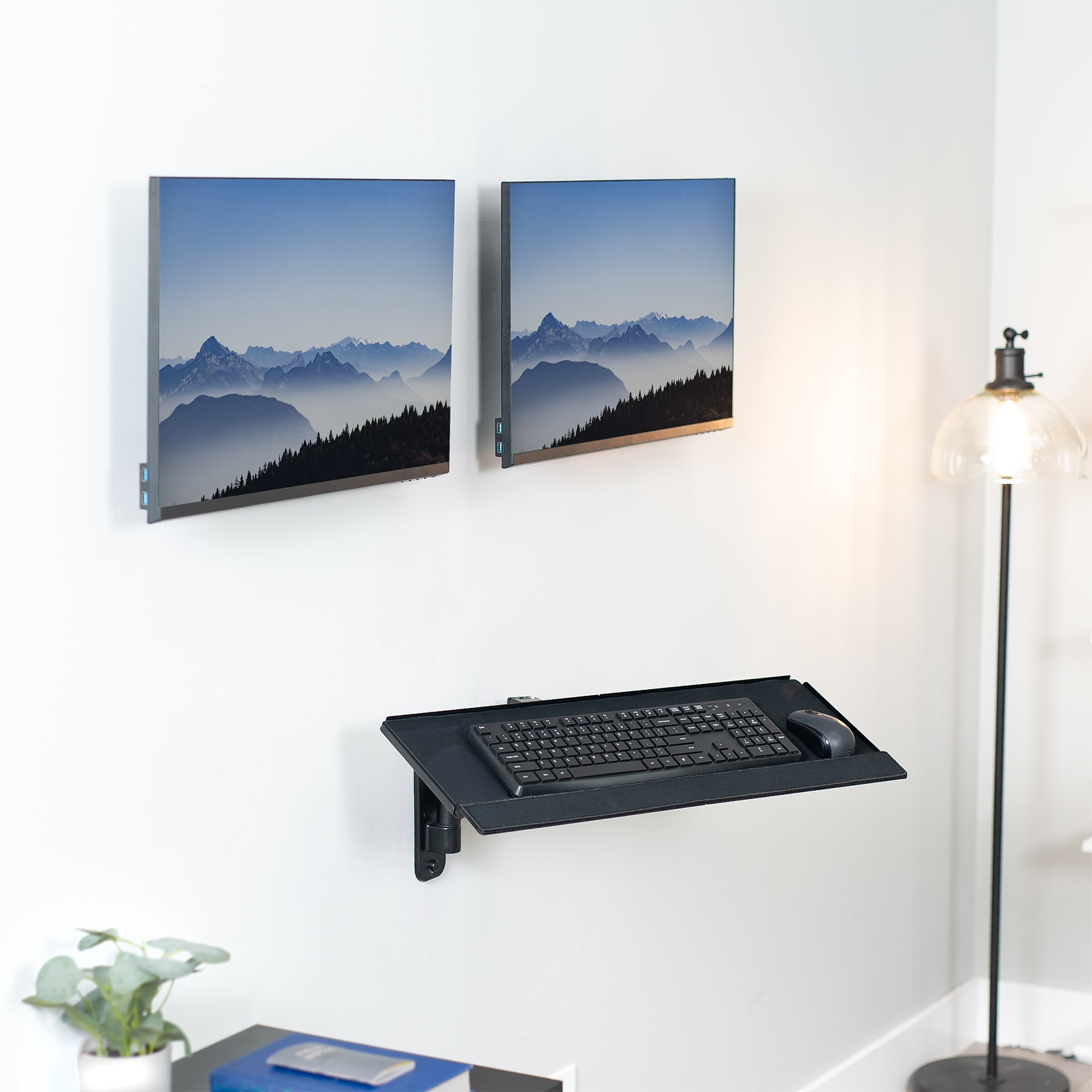 Dual monitor wall mount and height adjustable keyboard tray create a complete wall-mounted workstation.