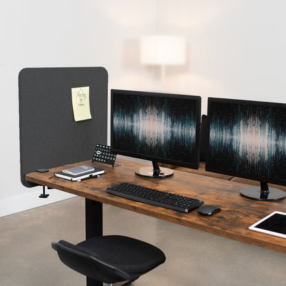 Clamp-on desk privacy panel for office workspace.